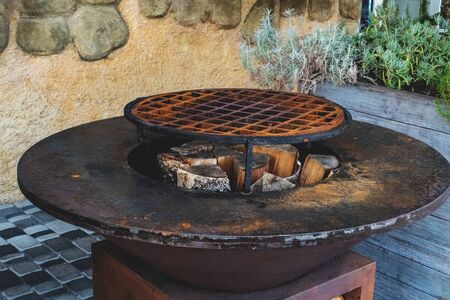 Outdoor wood-burning grill for frying steaks and pork ribs over an open fire. Street food concept.の写真素材