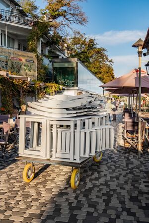 Yalta, Crimea, Massandra beach October 6, 2018: autumn on the beach. Sun loungers, umbrellas and other beach accessories worker picks up for winter storageのeditorial素材