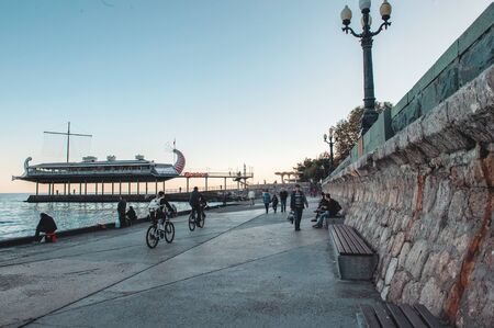Yalta, Crimea-October 9, 2019: people walk enjoying the view of the sea landscape at sunset on a warm Sunny autumn eveningのeditorial素材