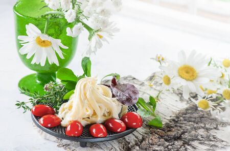 Traditional white soft fibrous Cecil cheese lies on a plate. The cheese is decorated with ripe...