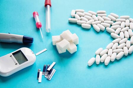 Diabetes. Glucometer. A device for measuring blood sugar levels. Test strips on a blue background....