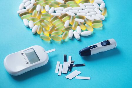 Diabetes. Glucometer. A device for measuring blood sugar levels. Test strips on a blue background....