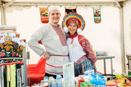 Moscow, Russia-October 1, 2016: descendants of Cossacks at the fair and Cossack gathering. A Cossack and a Cossack woman in national clothes sell hand-made crafts and food. Editorial.のeditorial素材