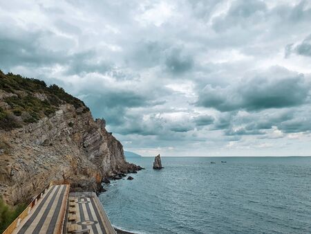 View from the height of the mountain on the rock Parus and the Black sea in the region of Yalta Crimea. Beautiful view of the sea on a cloudy overcast day.の写真素材