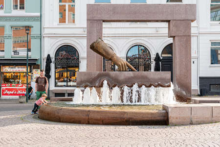 Oslo, Norway-July 26, 2013: a Hansen fountain glove with a sculpture of the hand of king Christian IV indicating the location of the new city on Christiania Torv square in Kvadraturen. Monuments and sculpture groups in Oslo. Editorialのeditorial素材