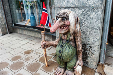 Oslo, Norway July 26, 2013: a Stone Troll figure on a street in Oslo, Norway at the entrance to a store. Trolls are evil characters in popular Scandinavian folklore. Editorial.のeditorial素材