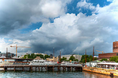 Oslo, Norway, July 27, 2013: port, Oslo's port area with vintage sailboats on a cloudy day. Editorial.のeditorial素材