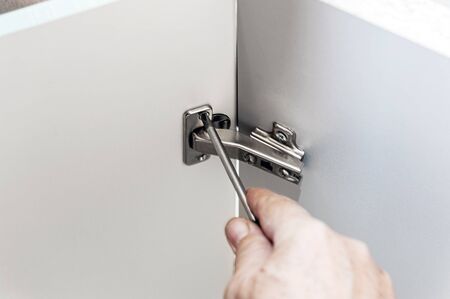 master builds a furniture Cabinet. Mounting for furniture panels. Assembling the Cabinet door...