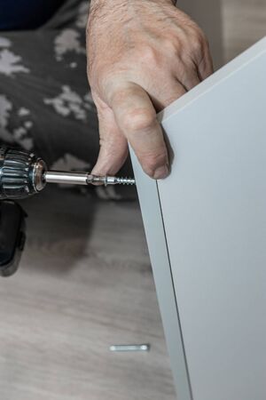 master builds a furniture Cabinet. Mounting for furniture panels. Assembling the Cabinet door...
