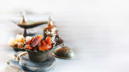 old vase with dates and a Cup of tea. Beautiful still life for a Muslim holiday. Copy space.の写真素材