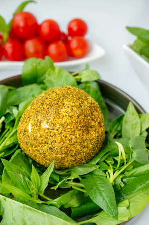 Small balls of Swiss hard cheese Belper Knolle, made from cow's milk. A round yellow fresh ball of...