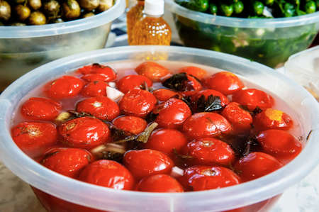 Street market stall with vegetables for sale. Fermented tomatoes are sold at the farmers  market in...