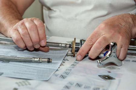 hands plumber at work in the bathroom, plumbing repairs, Assembly and installation of a bath faucet....