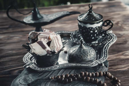 Sunflower halva in the national Turkish dish on a wooden background. Festive Oriental delicacy with tea. Dead life. Close up.の写真素材