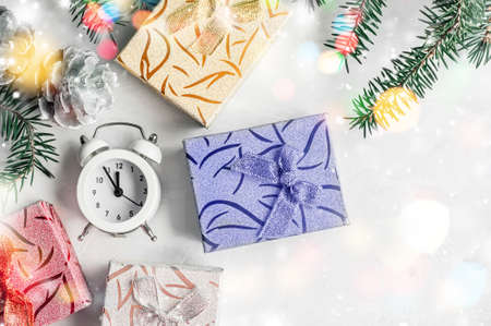 bunch of colorful Christmas gifts and new year's clock on a light uniform background top view. Copy space.の写真素材