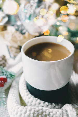 Hot chocolate or cocoa on the Christmas table. Highlights from the garland in the Cup. Hot winter drinks in a cozy still life.の写真素材