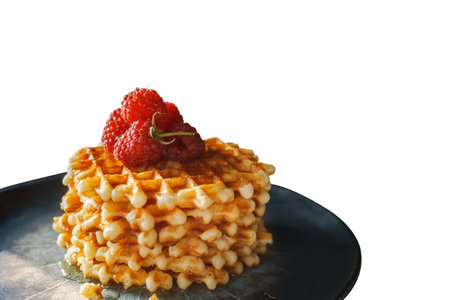 for Breakfast, sweet Viennese waffles are served with fresh ripe raspberries on a beautiful plate. Isolated on white.の写真素材