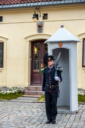 Oslo, Norway-July 27, 2013: Sentry on duty. A soldier of the Norwegian Royal guard of honor stands with a semi-automatic rifle in front of the guardhouse at Akershus fortress in Oslo.のeditorial素材
