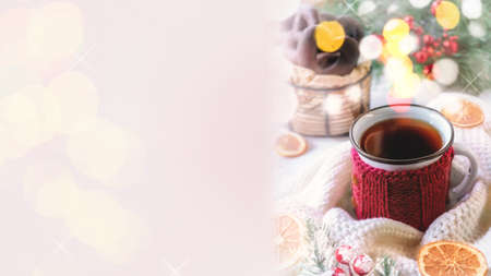 Cup of tea or coffee, wool knits, a blanket and Christmas. Copy space.の写真素材