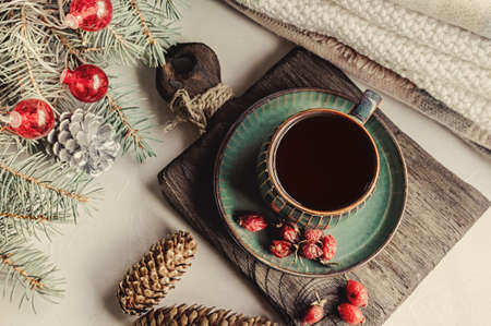 Cup of tea or coffee with a kettle for Christmas. Christmas still life. Warming winter tea with vitamins from rosehip. top view.の写真素材