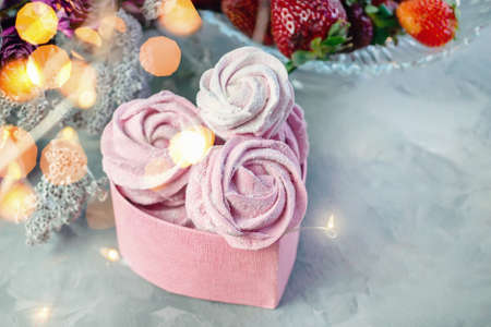 fresh handmade marshmallows in a light mood. Close-up of a pink marshmallow in a pink heart-shaped gift box.Fruit marshmallows with fresh strawberries. Selective focus.の写真素材