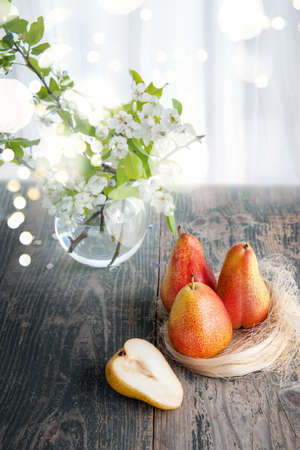 Ripe juicy yellow pears lie on a wooden table. Rustic still life.の写真素材