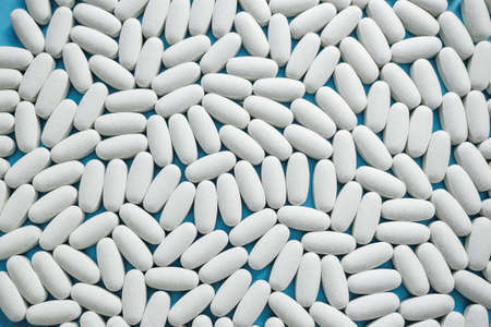 White large tablets are medicines for the treatment of various diseases. Close-up, background.