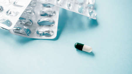 One capsule with empty packages. The medicine ran out. Concept of recovery and end of treatment.の写真素材