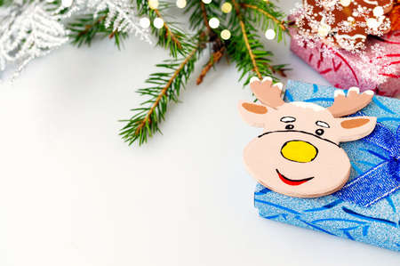 Toy elk moose on a blue gift box. Animation for a happy New year greeting card. Christmas card. Background for the text.の写真素材