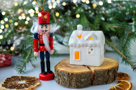 White house in the form of a ceramic candlestick on the background of decorative branches with a...