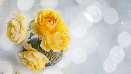 bouquet of orange roses in a round vase. Close-up of yellow peony roses. Copy spaceの写真素材