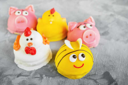 Cake in the form of animals. Homemade souffle in glaze is decorated in the form of animal faces....