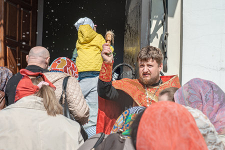 Kolomna, Russia May 1, 2016. Easter morning service. The priest sprinkles people with holy water at...