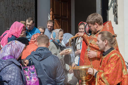 Kolomna, Russia May 1, 2016. Easter morning service. The priest consecrates Easter with holy water.