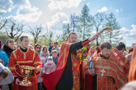 Kolomna, Russia May 1, 2016. Easter morning service. The priest sprinkles people with holy water at...