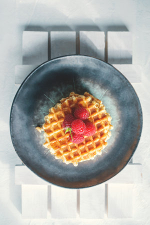 Homemade Viennese waffles with ripe raspberries. Top view.の写真素材