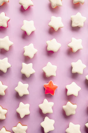Background of jelly candies in the shape of a star. Stars of fruit marmalade on a pink solid background. Top view.の写真素材