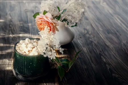 coffee with marshmallows. a delicious drink made of cocoa or hot chocolate with marshmallows in a cup on a wooden table. Still life in a rustic style with a beautiful openwork light. Copy spaceの写真素材