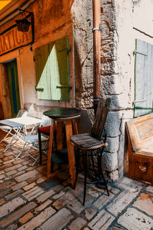 ROVINJ, CROATIA-AUGUST 30, 2018: an old table and chair on the street of the centuries-old...