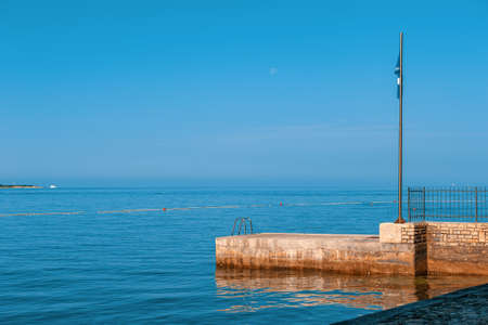 European pier for boats and swimming. Stairs to the sea for swimming lovers. Convenient holders to avoid slipping and fallingの写真素材