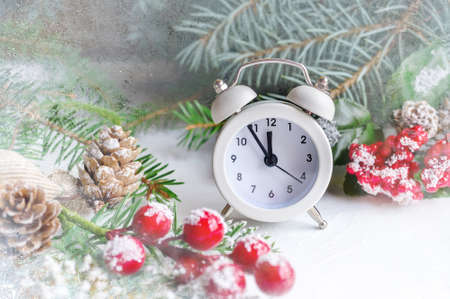 Christmas card with an alarm clock and gifts in boxes under the Christmas tree. A ready-made Christmas and New Year greeting cardの写真素材
