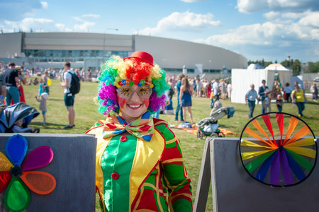 August 23, 2015, Kolomna, Moscow region. girl in a bright image of a clown on a city street. emotional portrait of a student. costumed presentation of a children's animator. clown woman.のeditorial素材