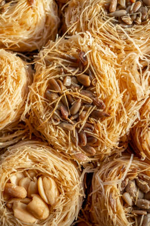 Baklava dessert with roasted peanuts from crushed filo dough in the shape of a bird's nest. Food...
