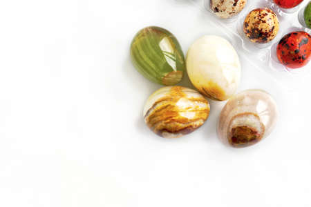 colored onyx spheres isolated on a white background. Easter eggs made of natural onyx gemstone....