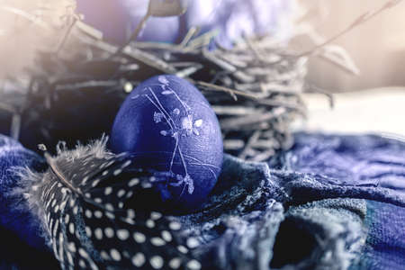 easter eggs in a round bird's nest with processed hay on the background of the nest, monochrome...