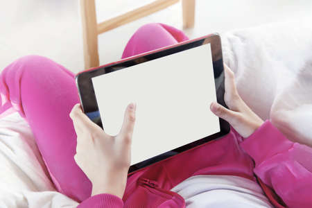 Hands holding a tablet with a white square on the screen. concept of online education and...