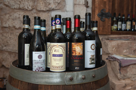 assortment of wine bottles. A rack with bottles of wine at the presentation.のeditorial素材