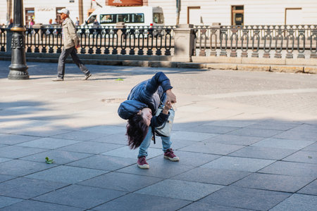 June 7, 2015 St. Petersburg, Russia : A tourist from China takes pictures of the Church of the Savior on Spilled Blood in St. Petersburg. The tourist chooses the angle for shooting.のeditorial素材
