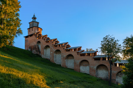 A fragment of the fortress wall of the Nizhny Novgorod Kremlin with a view of the northern tower in the rays of a summer sunset. Nizhny Novgorod, Russia.のeditorial素材