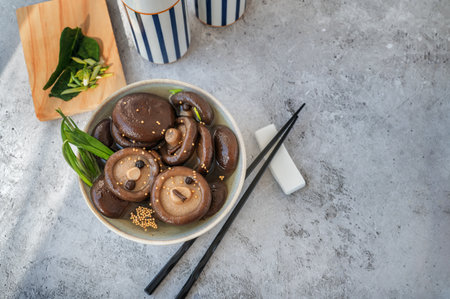marinated shiitake. canned shiitake on a plate close-up. Top view, space for textの写真素材